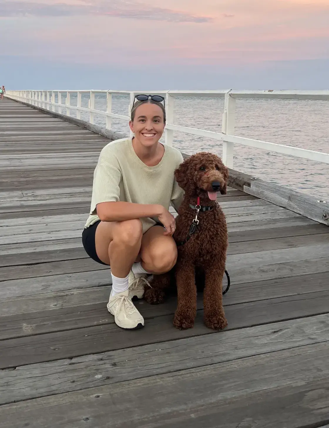 Maegan Morrison with her dog on a Sunshine Coast jetty